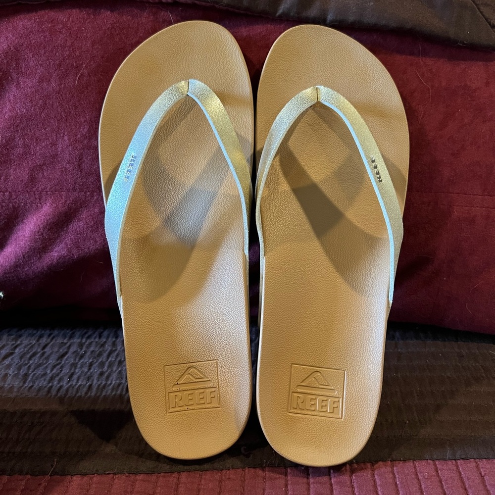 Like NEW Reef bounce court size 10 gold & tan flip flops; worn only once